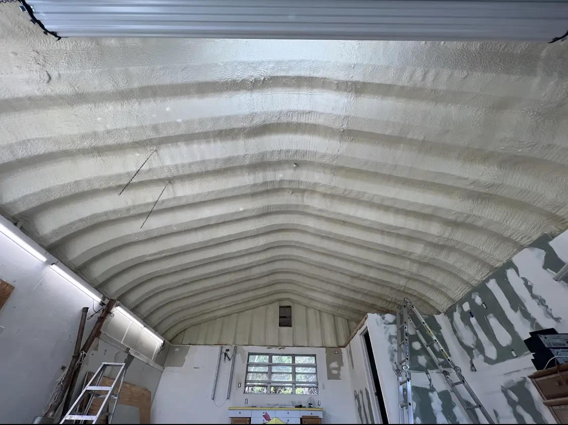 Spray polyurethane foam applied to the underside of a metal roof deck in Milton
